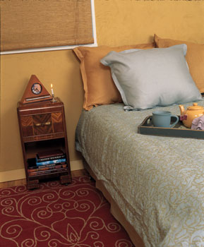 
Now a luxurious space that invites deep slumber and quiet relaxation, Hermine and Jean-Charles’s bedroom is also free of toxins and other harmful elements. The finishing touches on their bed include a comforter, courtesy Suite Sleep; a classic print duvet cover and pillowcases from Indika; and ­pillows from Pacific Coast Feather Company. A Zen Alarm Clock (available at Gaiam.com) on the heirloom bedside table will chime morning tidings to rouse them serenely from slumber. And stepping out of bed in the morning, their feet will land softly on a natural area rug, hand woven and naturally dyed from Garuda Woven Art (303-442-2096). Their new bedroom will luxuriate their senses while nourishing them physically and spiritually.

